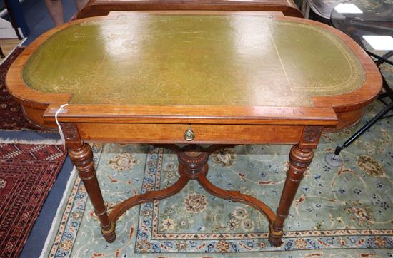 A Victorian walnut and ebonised centre table, inset leather skiver and having bowed ends on turned legs with shaped saltire stretcher W